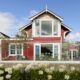Waterfront view of The Red Cottage with French doors open to the deck