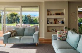 Family living room with sliding doors to louvre-covered deck at Tai Tapu alterations