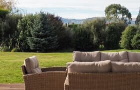 Louvre-covered outdoor living area linking living room to garden at Tai Tapu family home