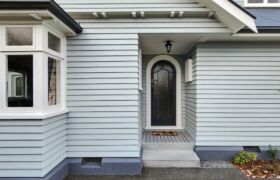 Traditional arched timber door leading from entry steps in character home, Christchurch