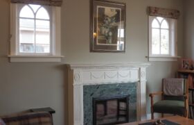 Original fireplace mantlepiece integrated into living space in heritage home renovation Christchurch