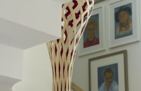 Close-up of the custom timber pendant with red interior, and sculptural stair