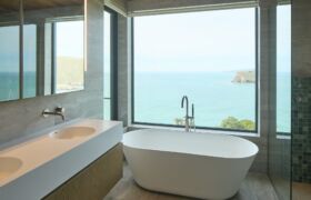 Ensuite bathroom at Scarborough House with refined finishes and glimpses of the coastline