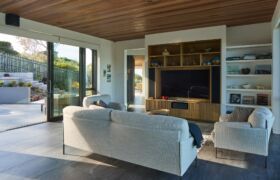 Open-plan living and dining space at Scarborough House with views to Godley Head