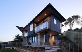 Garden paths and planted terraces wrapping around Scarborough House, connecting decks and outdoor rooms