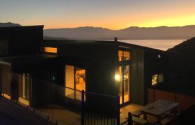 Sunset over Golden Bay viewed from the pool deck of Tata Beach House