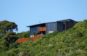 SONY DSC Front view of Tata Beach House perched on bush-clad hillside overlooking Golden Bay in the Tasman region