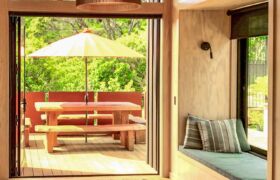 Cross-laminated timber walls and ceiling exposed inside modern Tata Beach coastal house